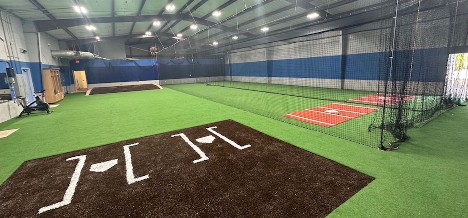 Indoor baseball training facility by Goat Turf