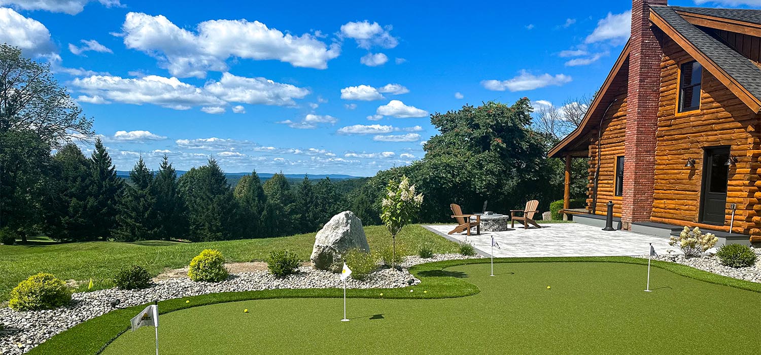 Outdoor fake grass putting green with majestic mountain view